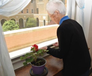 Sister Bernice tries to open a stuck window.