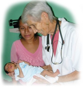 Sister Jane shown examining baby Joselito, 4 months old and weighing 3 pounds.