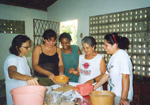 Sister Efu shows women how to make holistic medicine. 